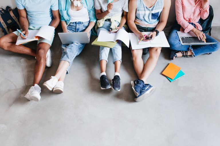 Overhead,Portrait,Of,Young,People,With,Laptops,And,Smartphones,,Sitting